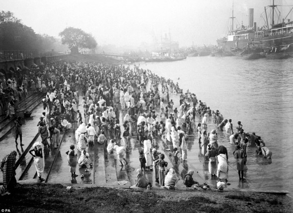 A crowded riverside with bathers at Chandpal Ghat in Calcutta