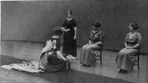 Debutantes, clad in their finery curtsey to King George V and Queen Mary  during a court presentation. Thus they are launched into  "Society". Date: 1928 - SuperStock